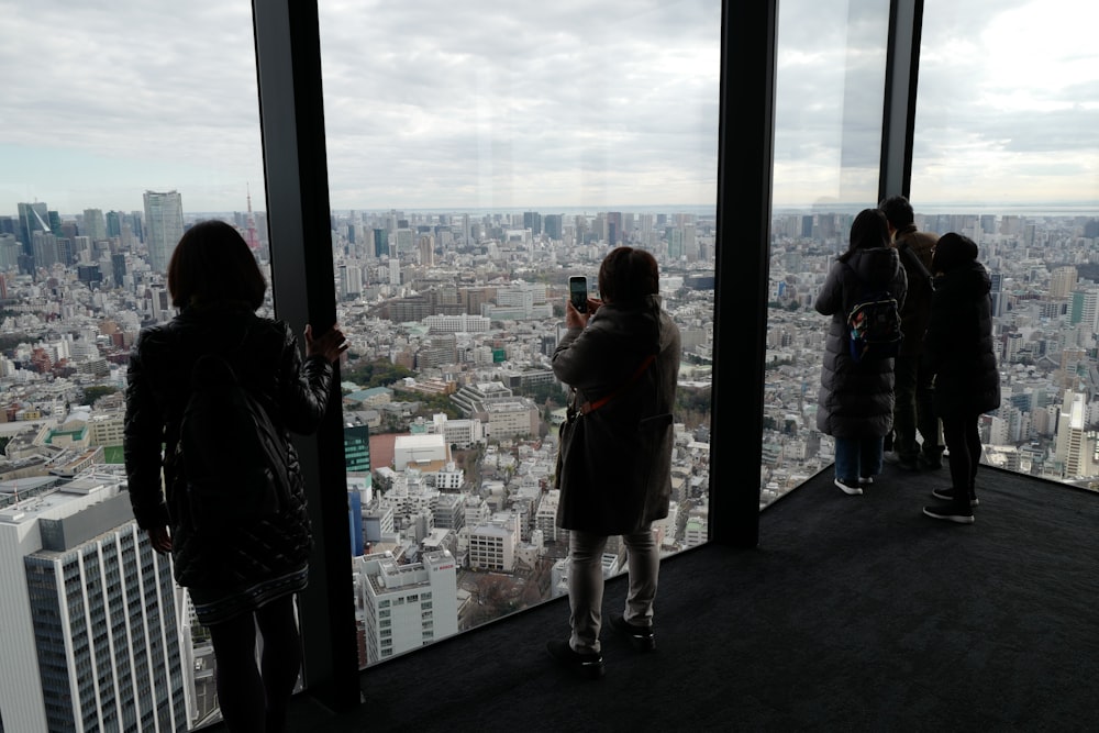 2 women standing in front of window