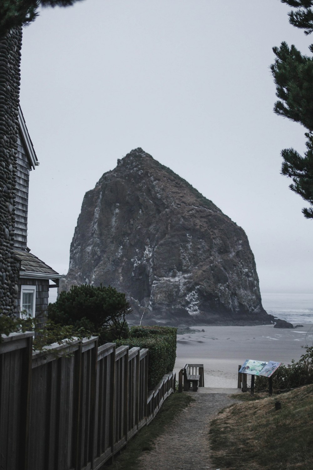 people on beach near brown rock formation during daytime