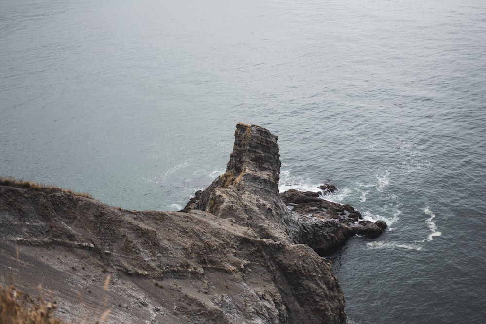 brown rock formation on sea during daytime