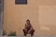 man in black shorts sitting on concrete floor