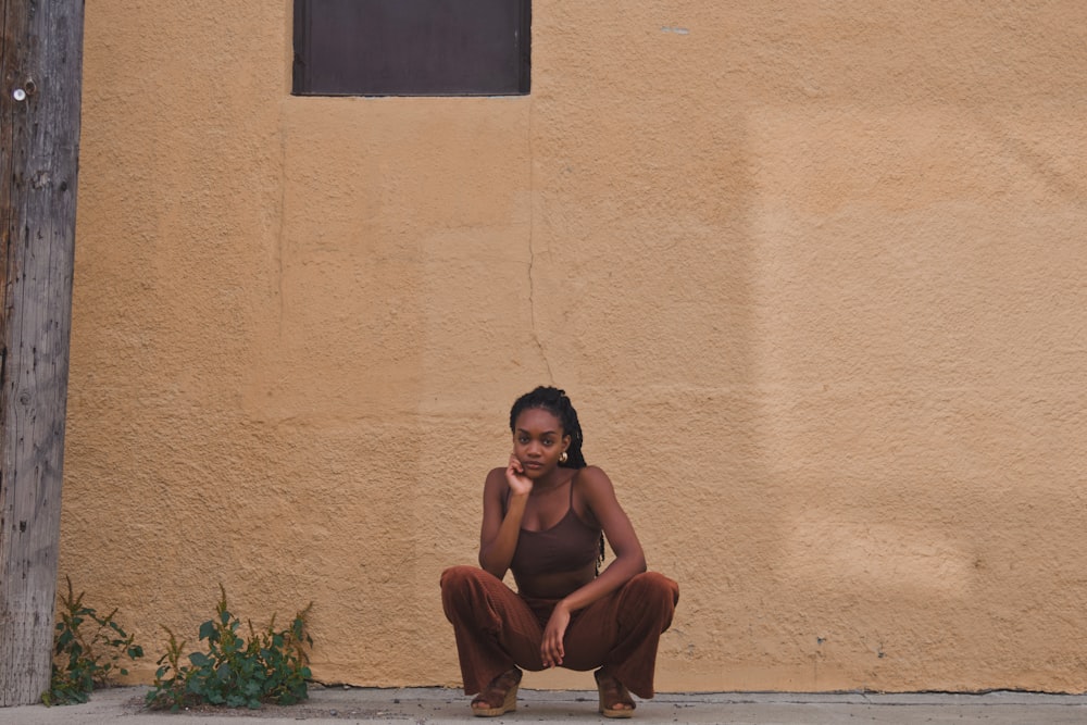 man in black shorts sitting on concrete floor