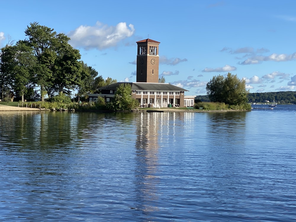 brown concrete building near green trees and body of water during daytime