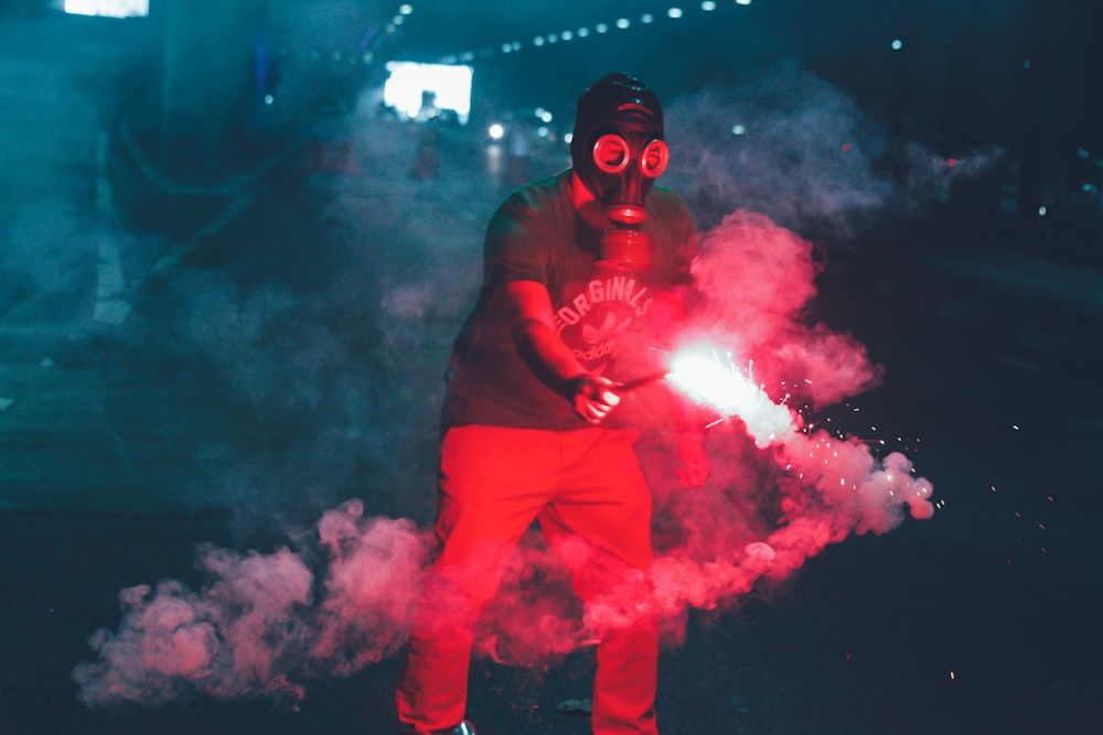 man in red long sleeve shirt and red pants with gas mask