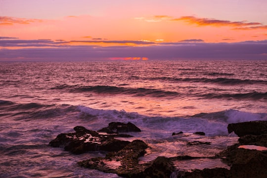 ocean waves crashing on rocks during sunset in Oualidia Morocco