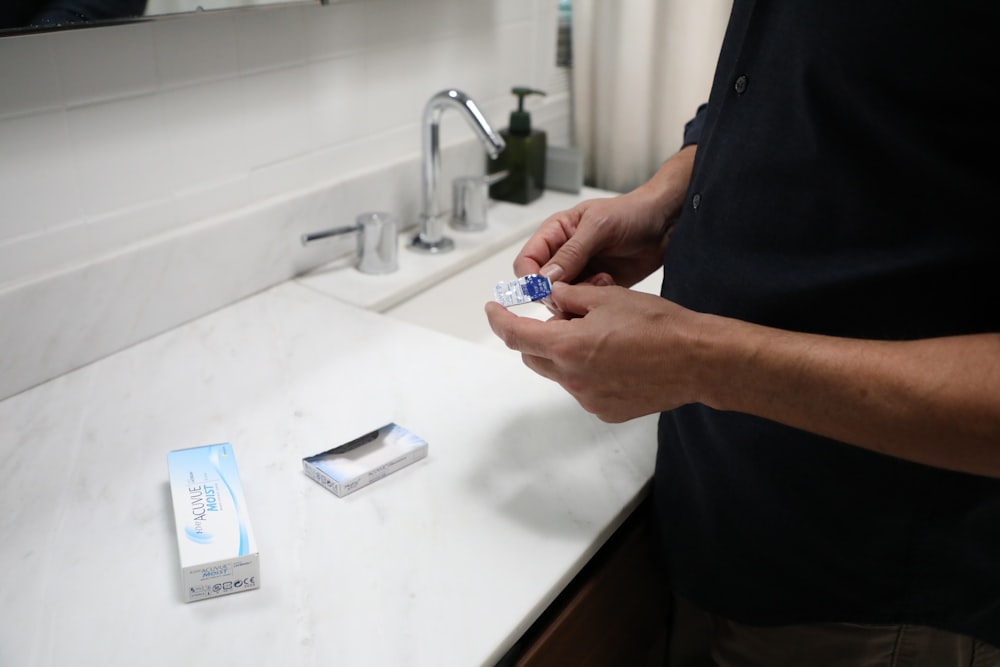 person holding blue and white plastic pack