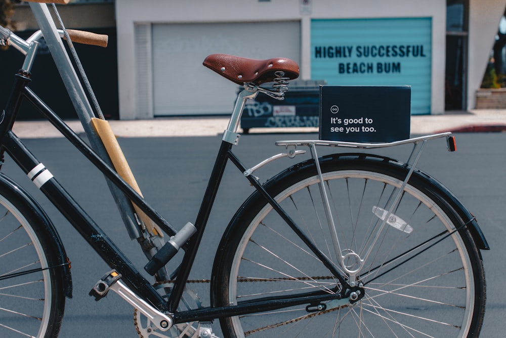 black and brown bicycle near white concrete building during daytime