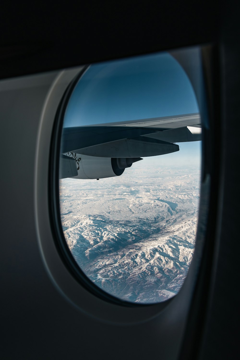 airplane window view of mountains during daytime