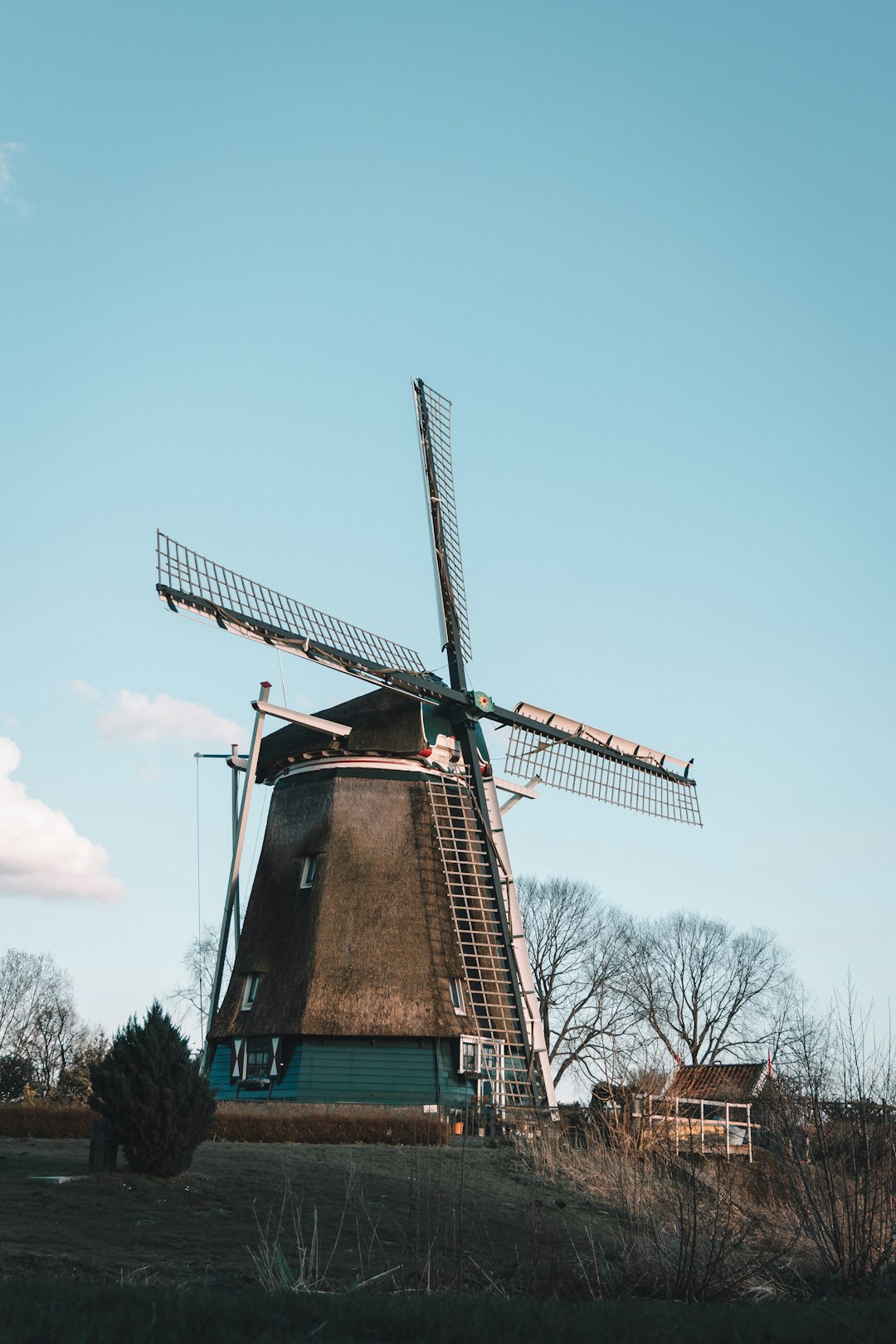 brown and green windmill under blue sky during daytime
