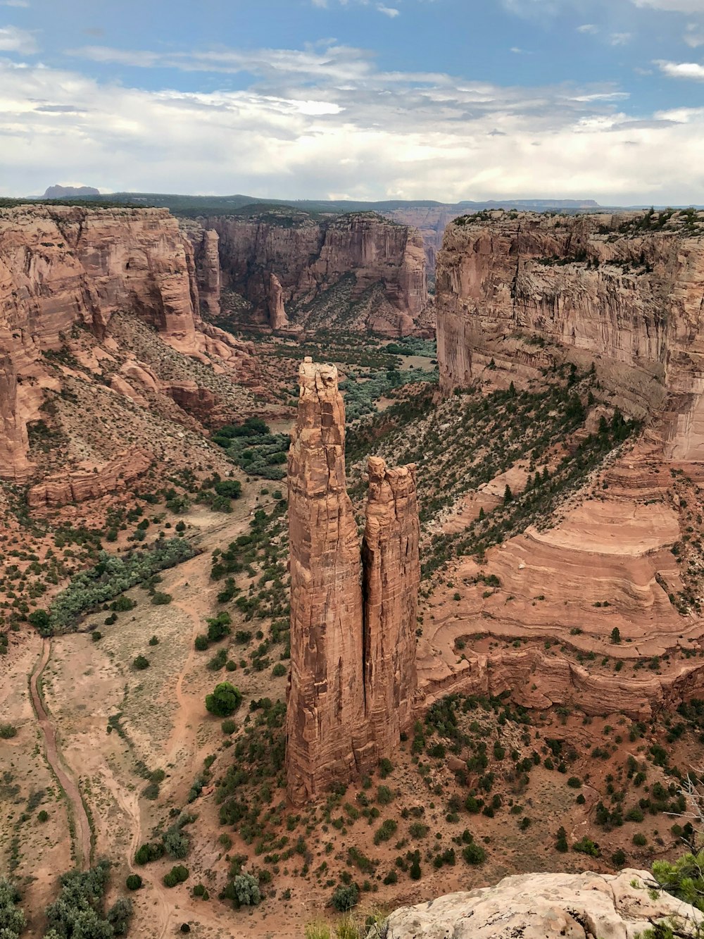 brown rock formation under white clouds during daytime