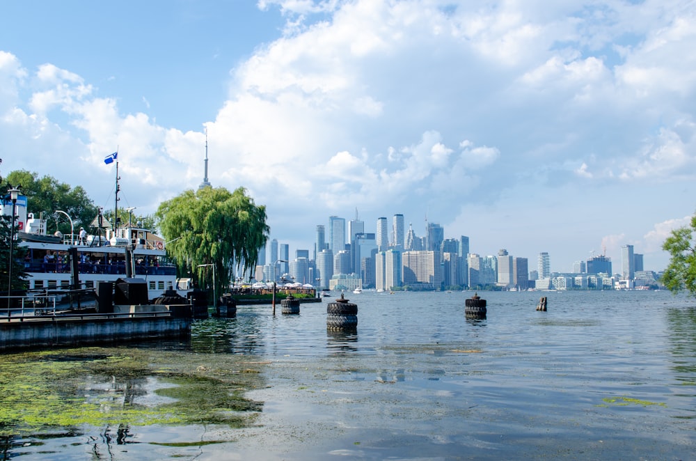 weißes Boot tagsüber auf dem Wasser in der Nähe von Stadtgebäuden