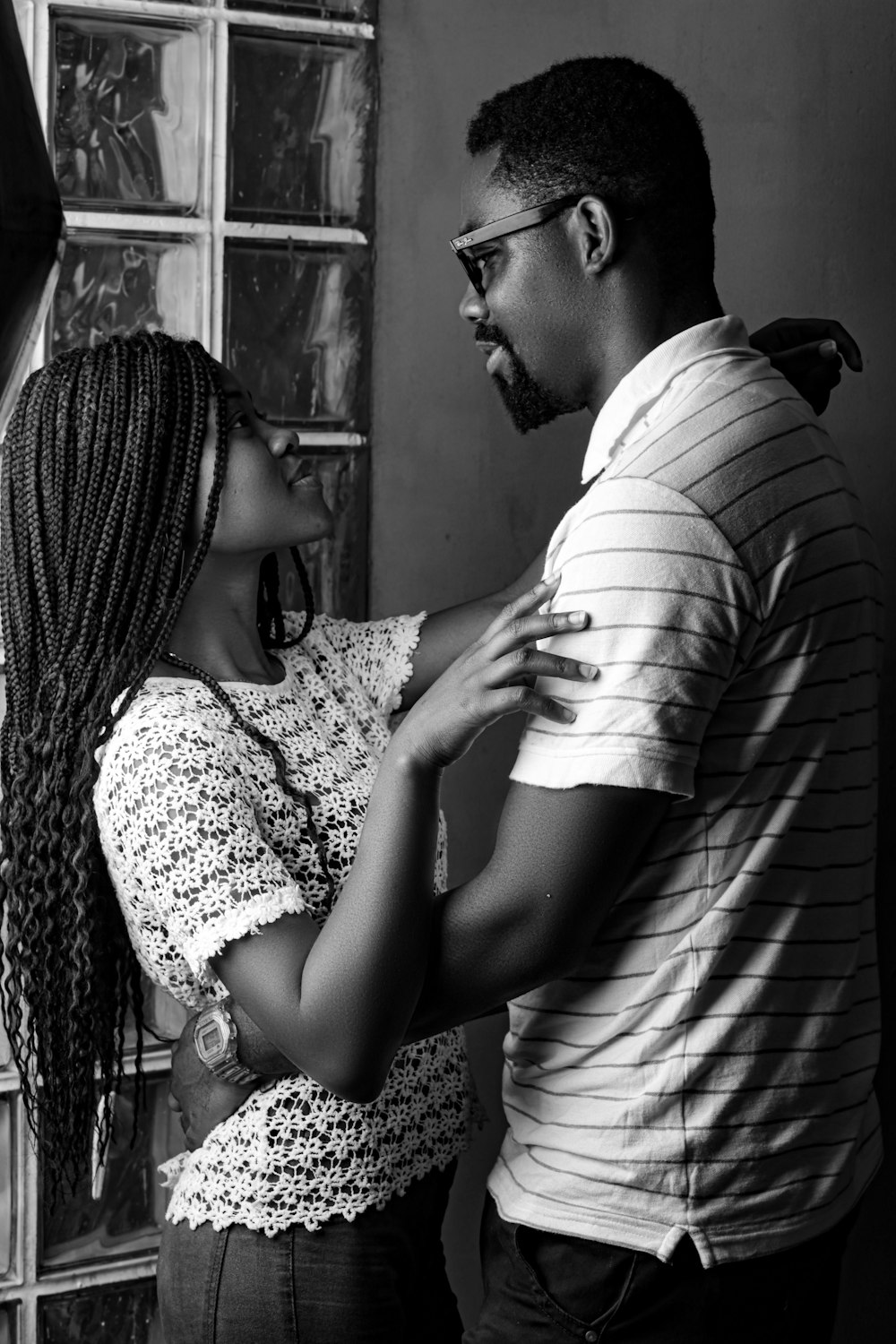 man and woman kissing in grayscale photography