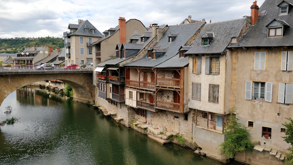 brown and white concrete building beside river during daytime