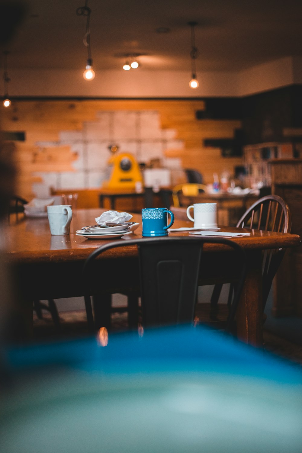 white ceramic mug on brown wooden table