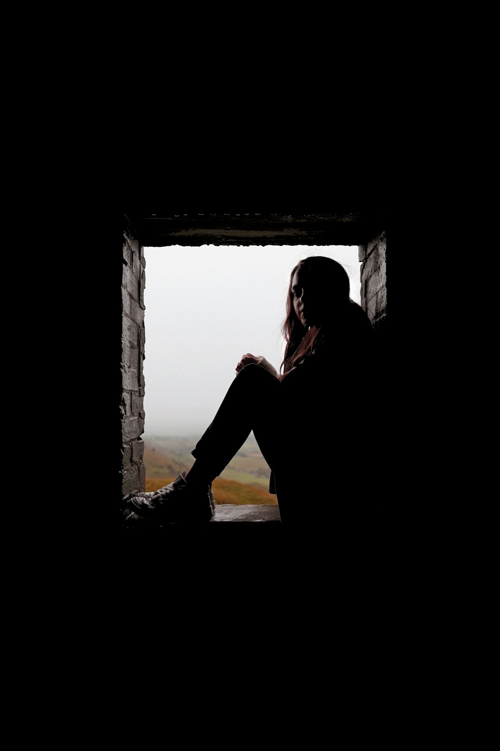 silhouette of woman in window