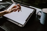 person holding white ipad with black case