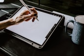 person holding white ipad with black case