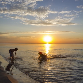 A vibrant beach sunset with a family playing near the shore, capturing joy and togetherness.