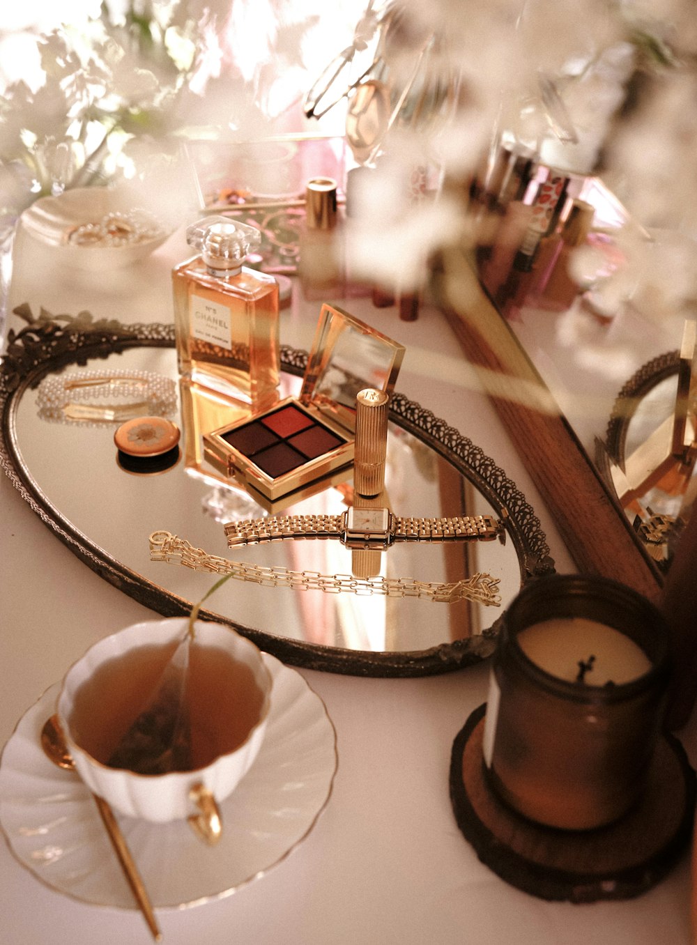 gold and white perfume bottle on round glass table