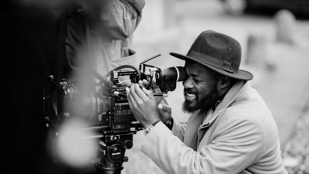 man in white dress shirt holding black dslr camera