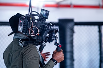 man in black jacket holding black video camera
