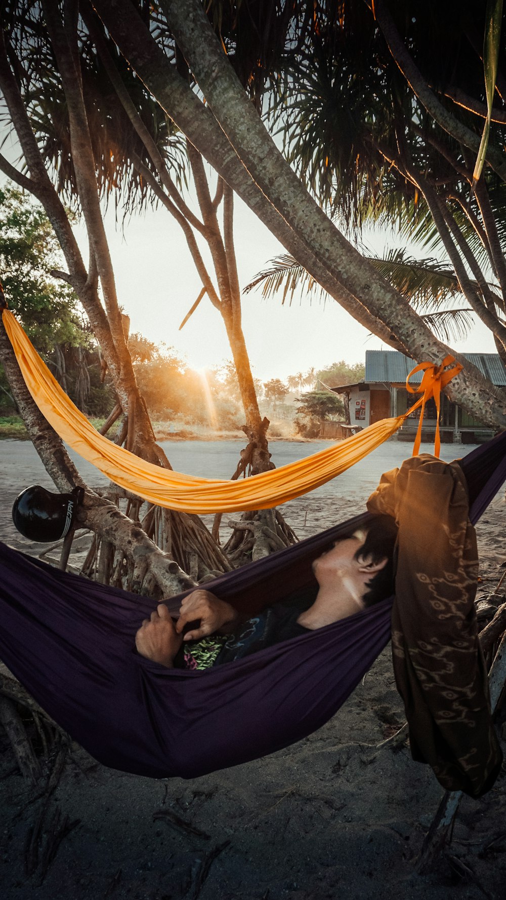 person in black long sleeve shirt sitting on hammock