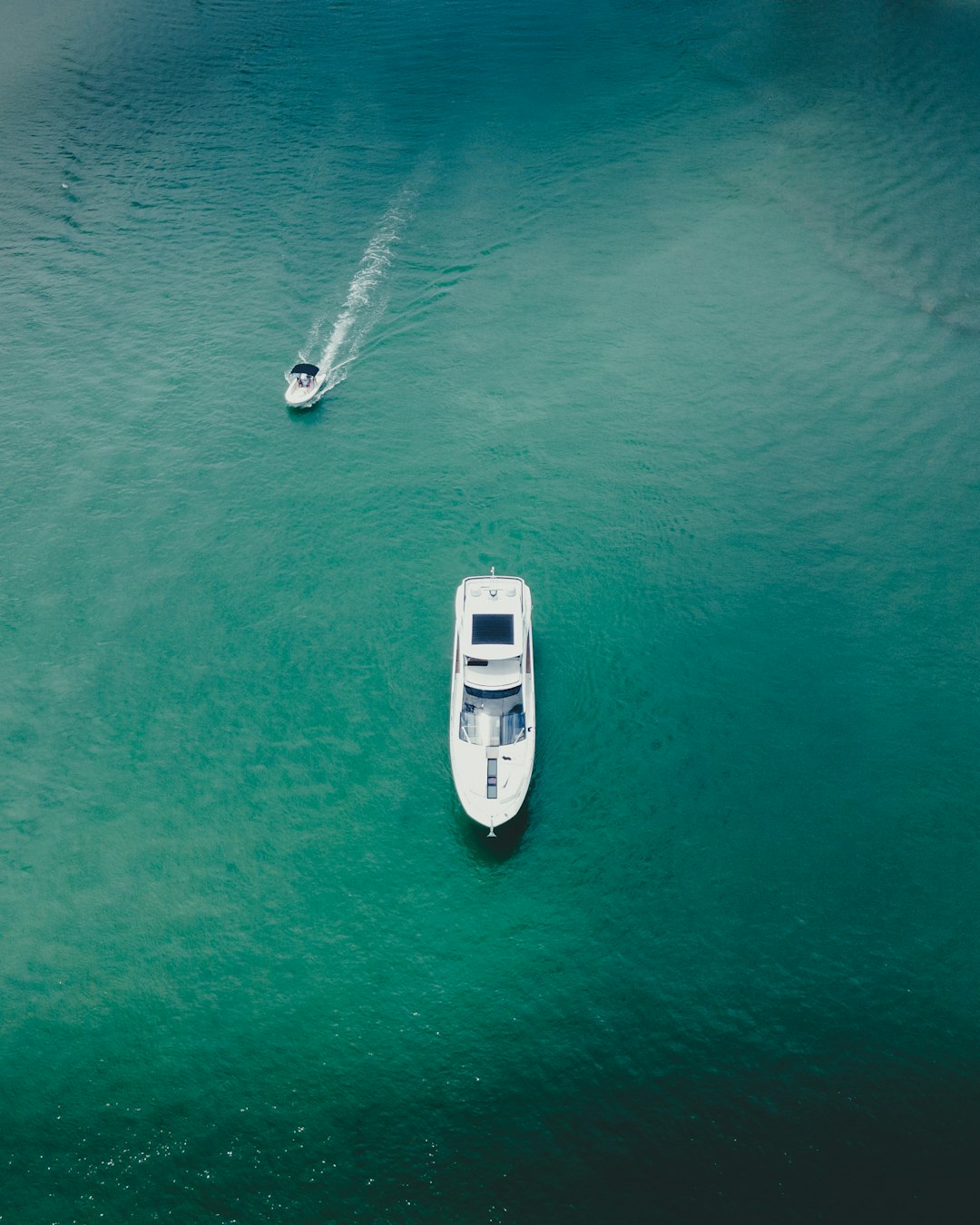 white boat on body of water during daytime