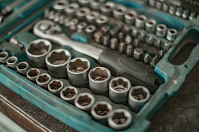 A 3D printed socket set arranged neatly on a workbench with automotive parts in the background.