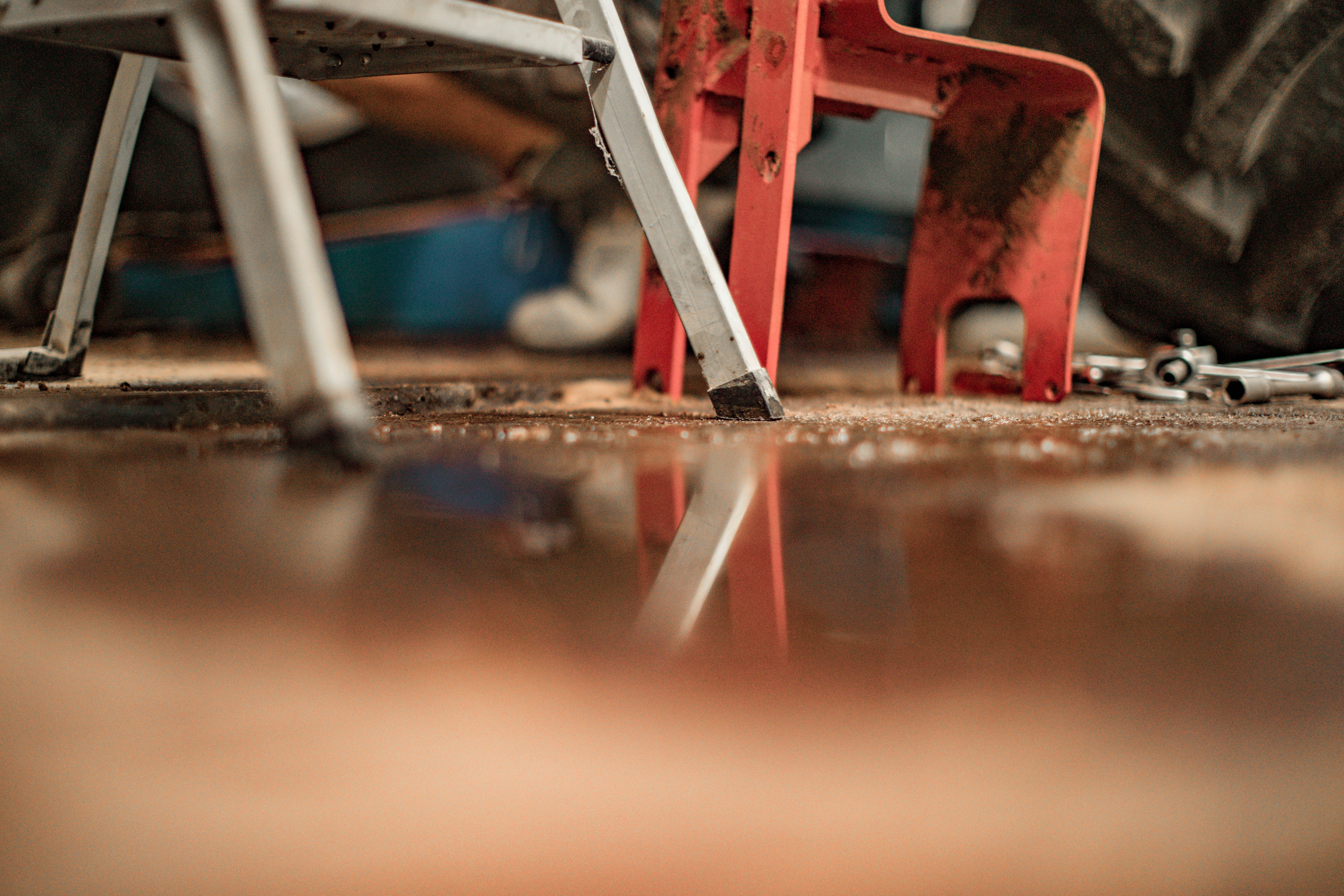 red metal frame on brown wooden floor
