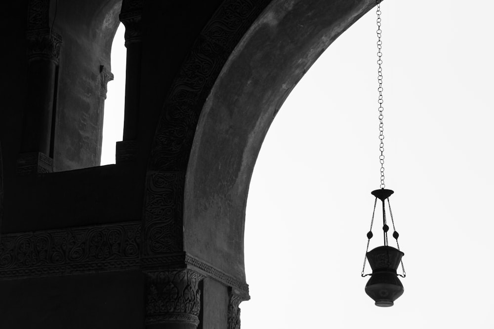 grayscale photo of hanging bell