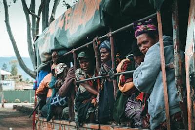 people in blue and red hat during daytime guinea-bissau teams background