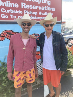 A cheerful family wearing cowboy hats and western shirts, smiling outside the storefront at 6509 Atlantic Avenue.