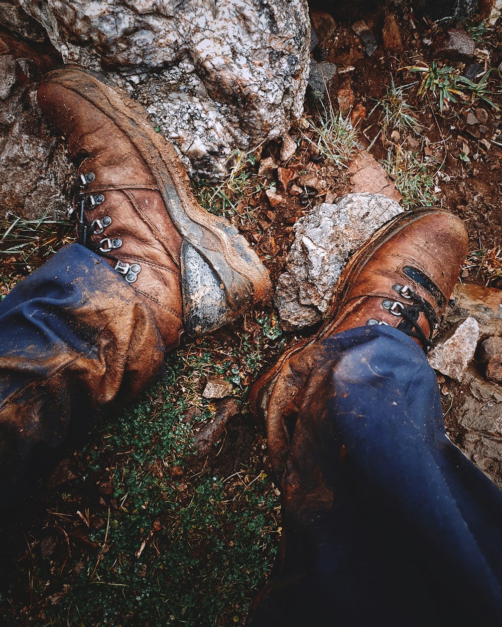 brown leather boots on brown and gray rock