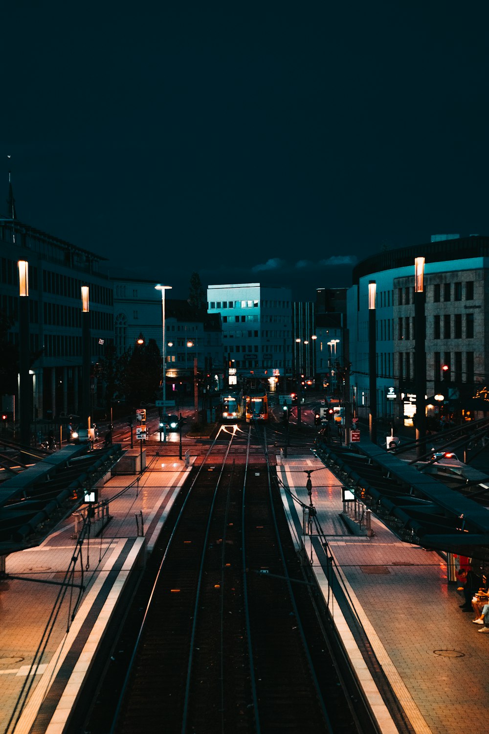 cars on road near buildings during night time