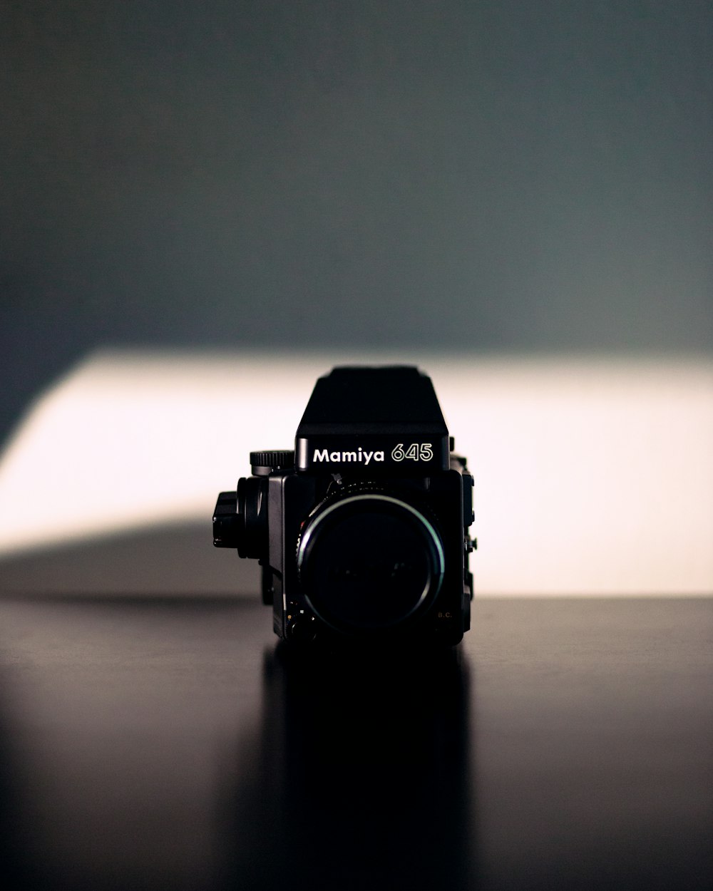 black nikon dslr camera on brown wooden table