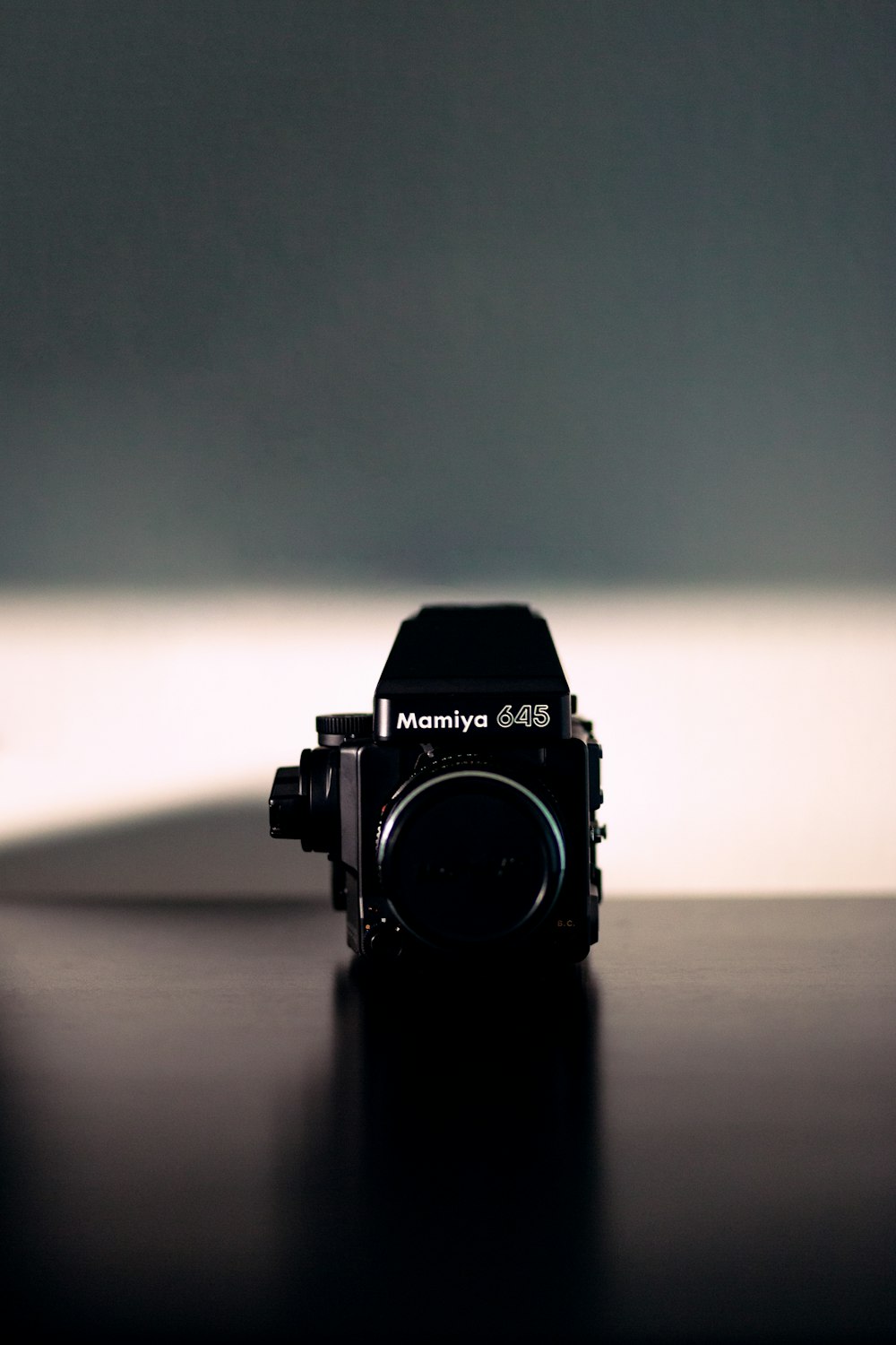 black nikon dslr camera on brown wooden table