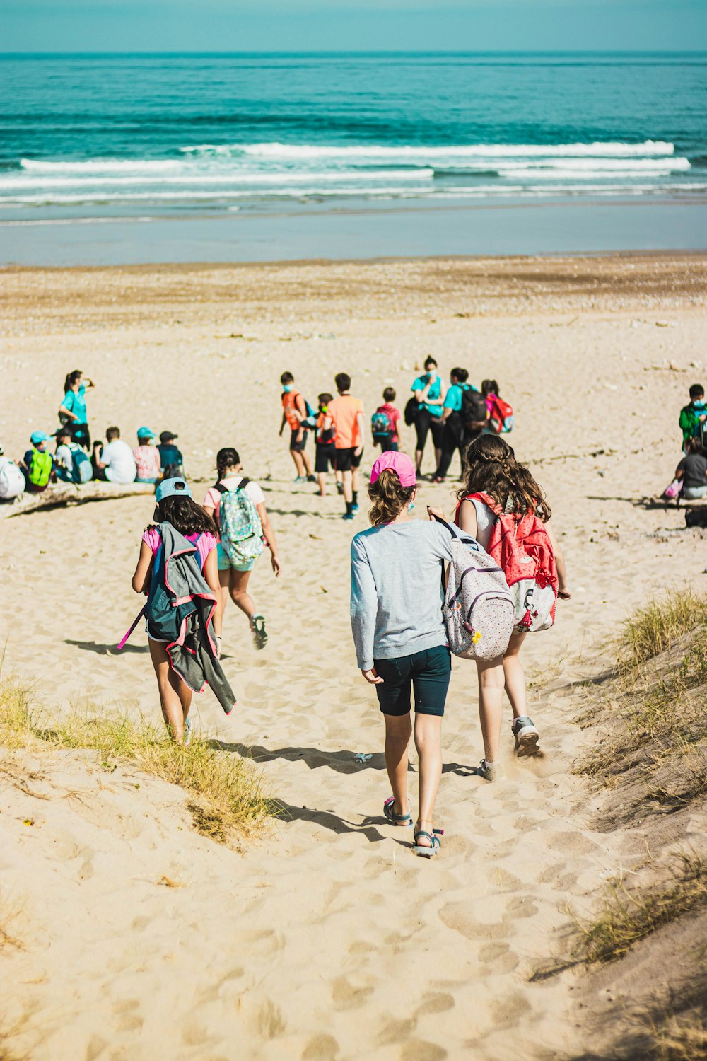 people walking on brown sand during daytime