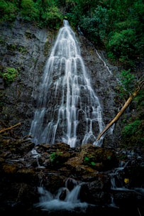 water falls on brown and green rock