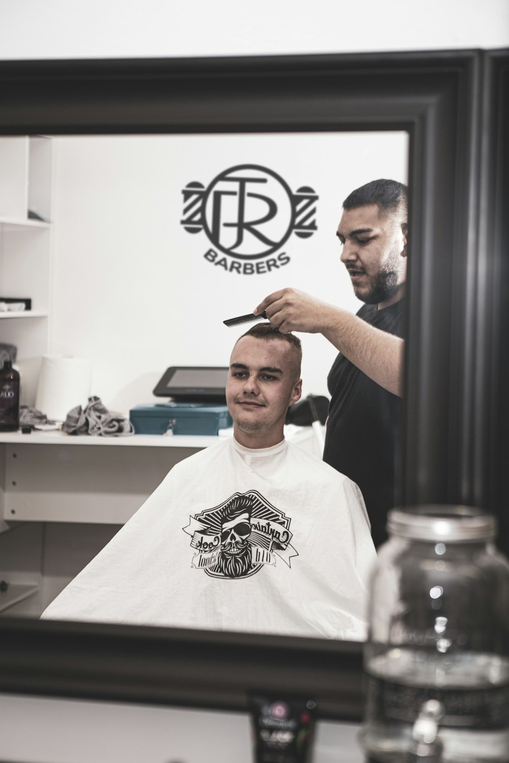 man in white crew neck t-shirt holding black hair brush