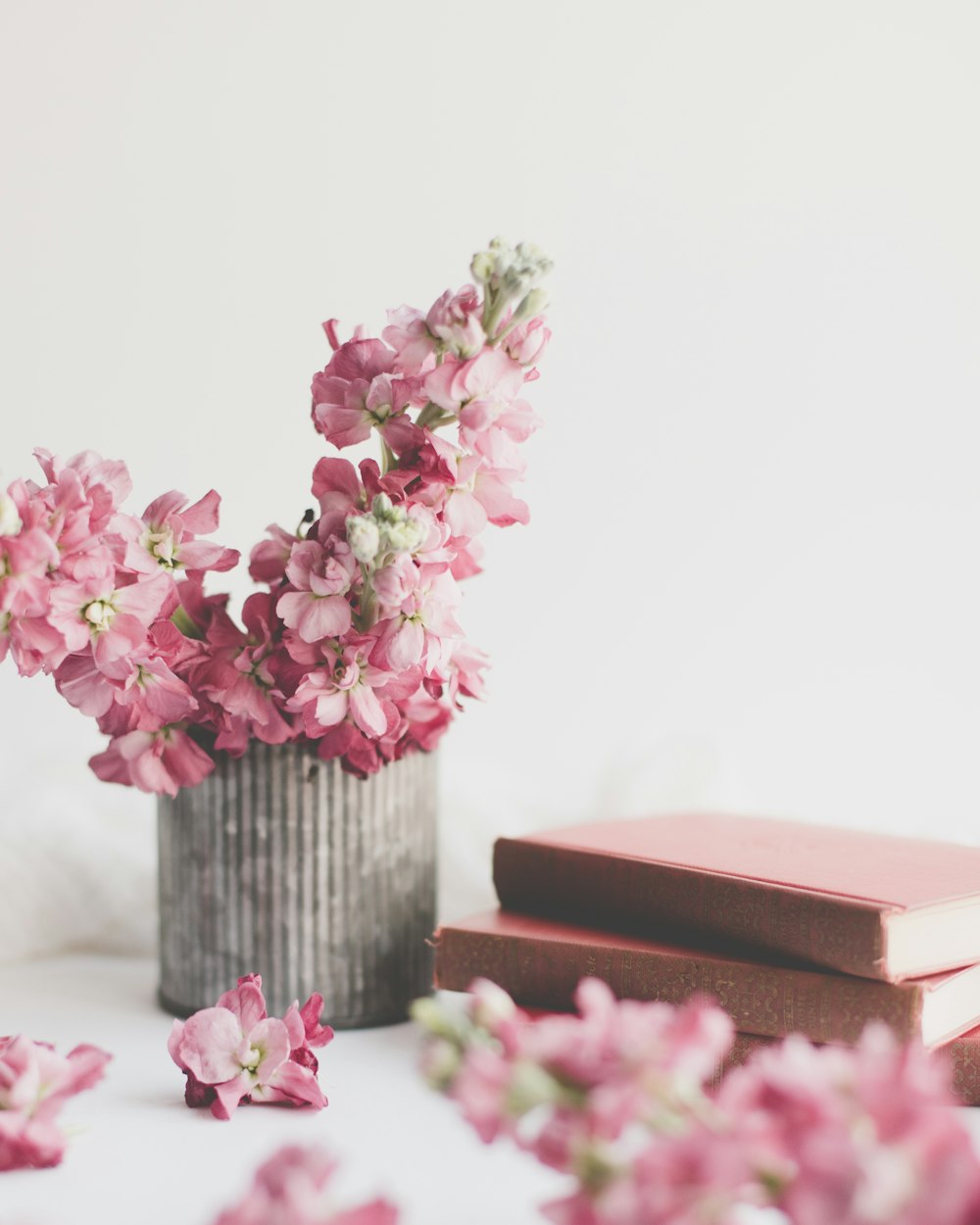 pink flowers on brown wooden vase