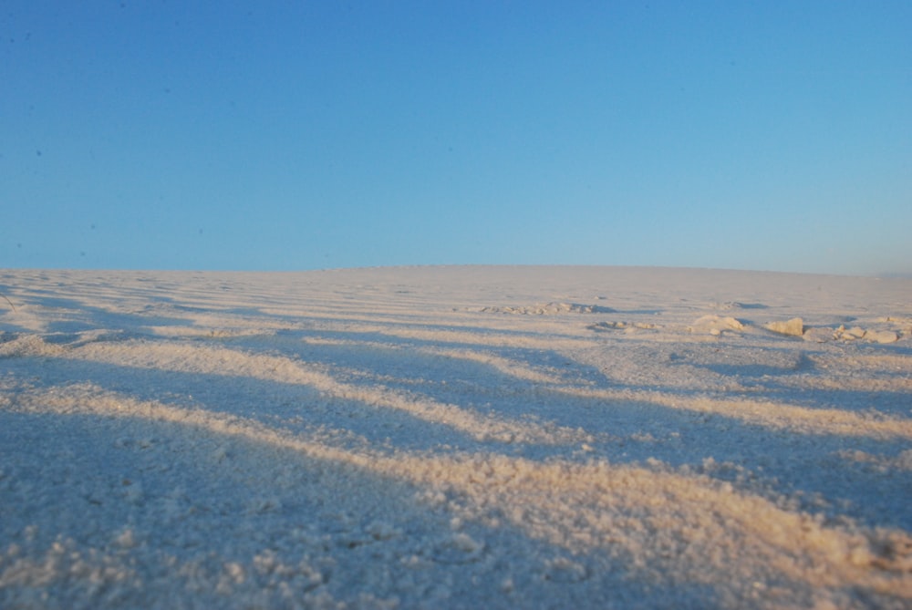 white sand under blue sky during daytime