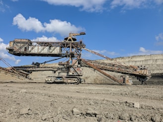 brown metal crane under blue sky during daytime