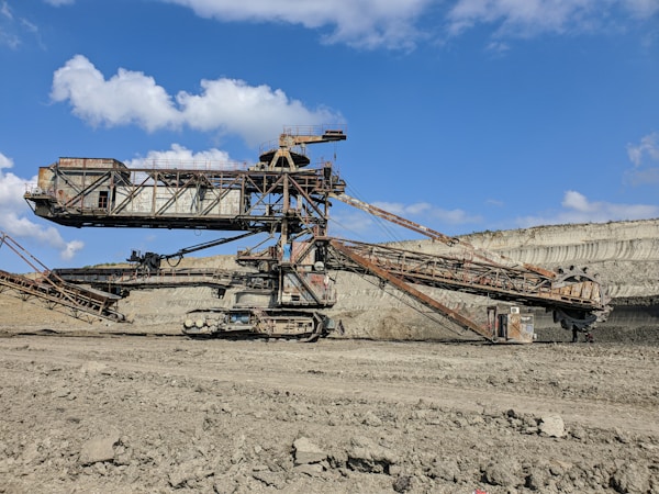 brown metal crane under blue sky during daytime