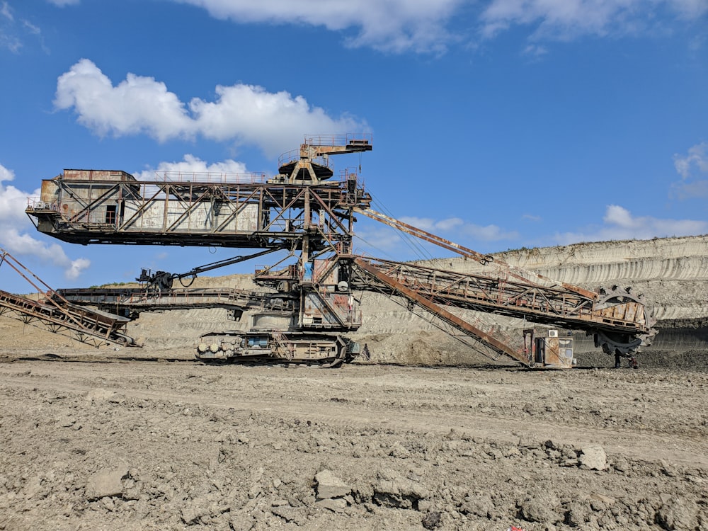 brown metal crane under blue sky during daytime