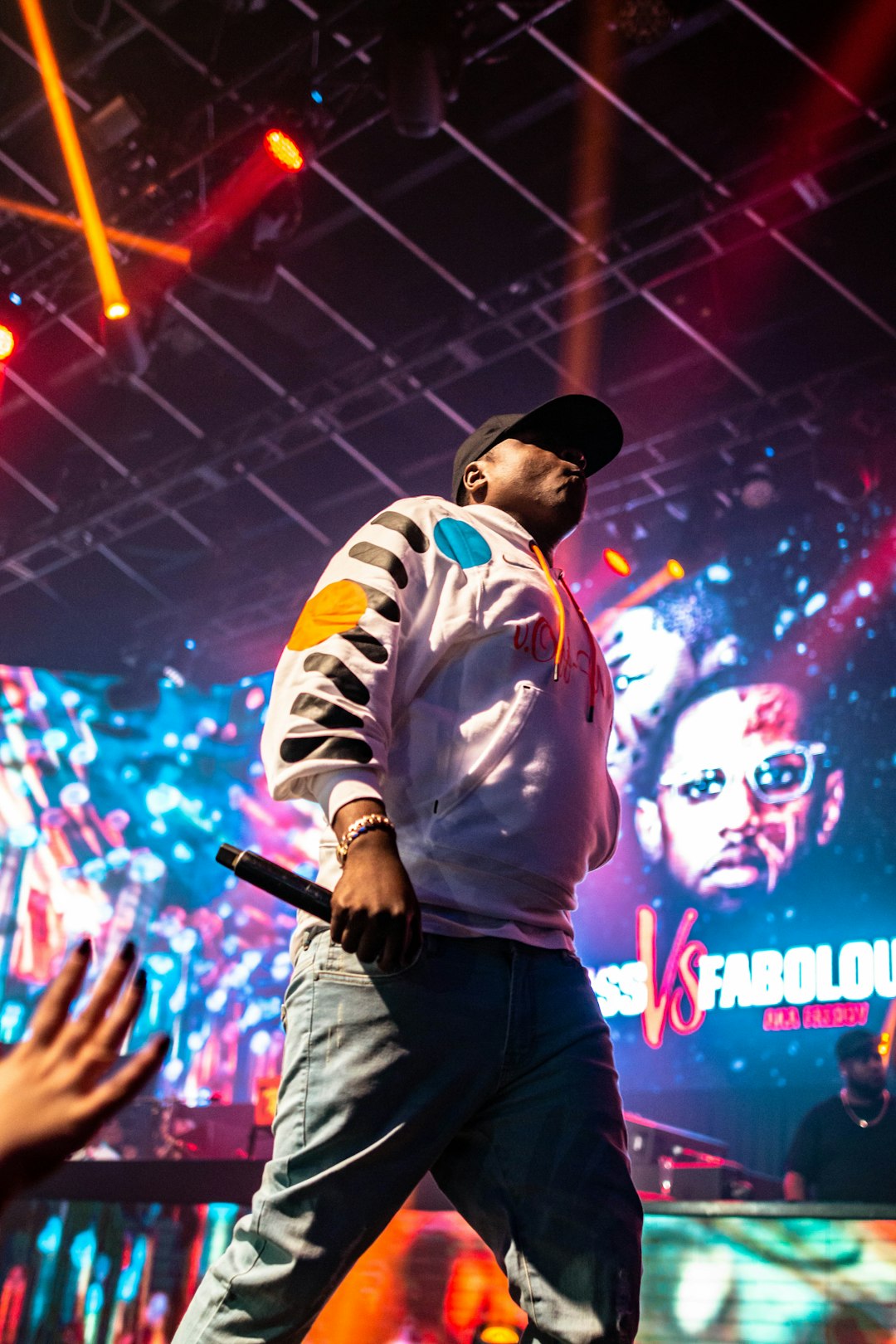 man in white and blue hoodie holding microphone