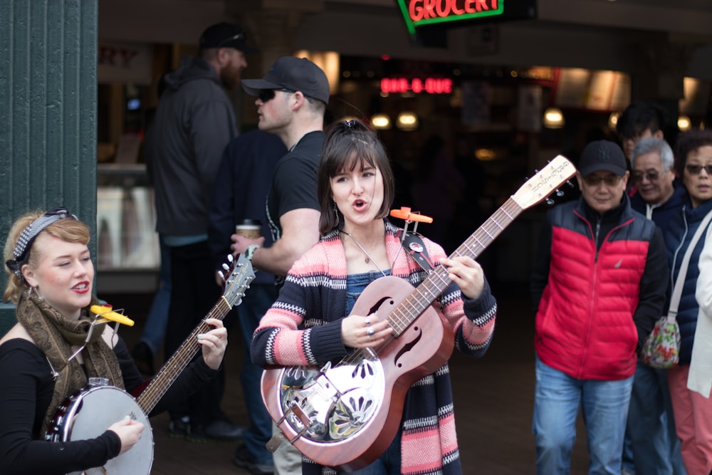 woman in red and white plaid dress shirt playing white electric guitar