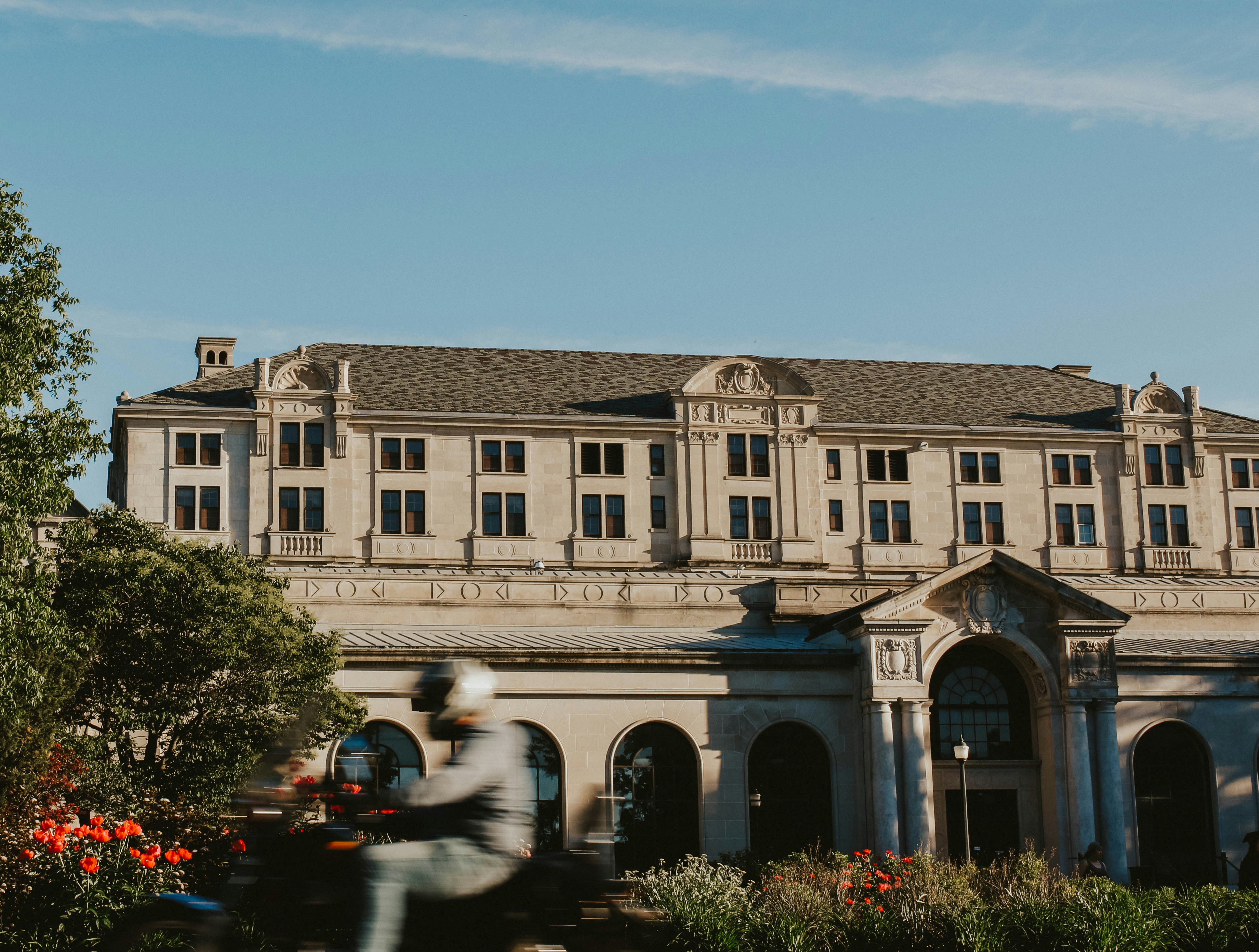 cars parked in front of white concrete building during daytime