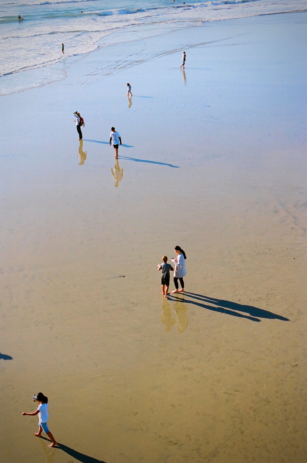 people walking on beach during daytime