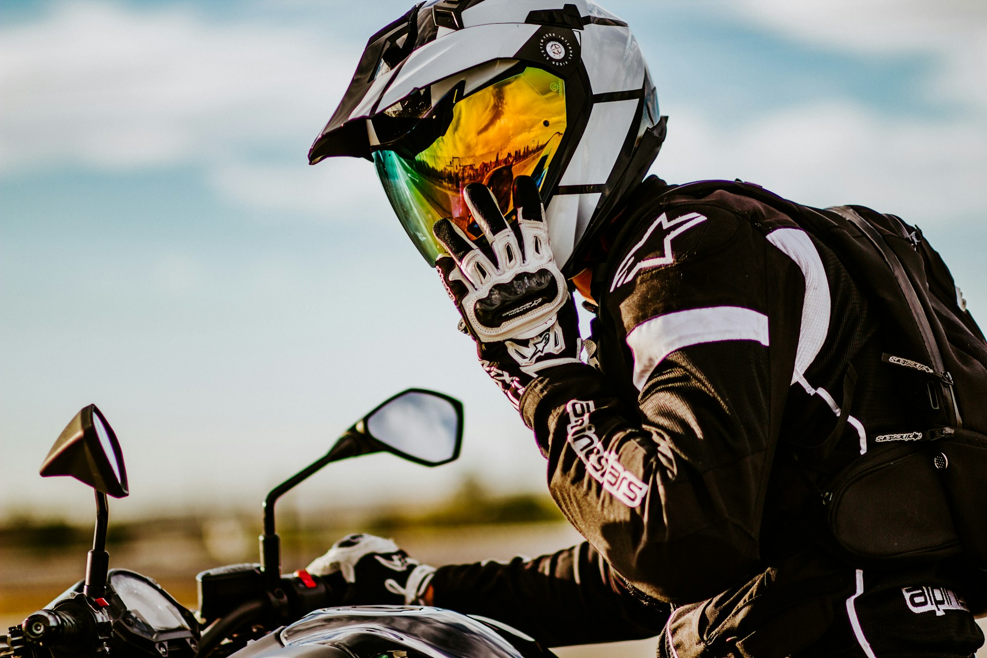 man in black and white helmet riding motorcycle