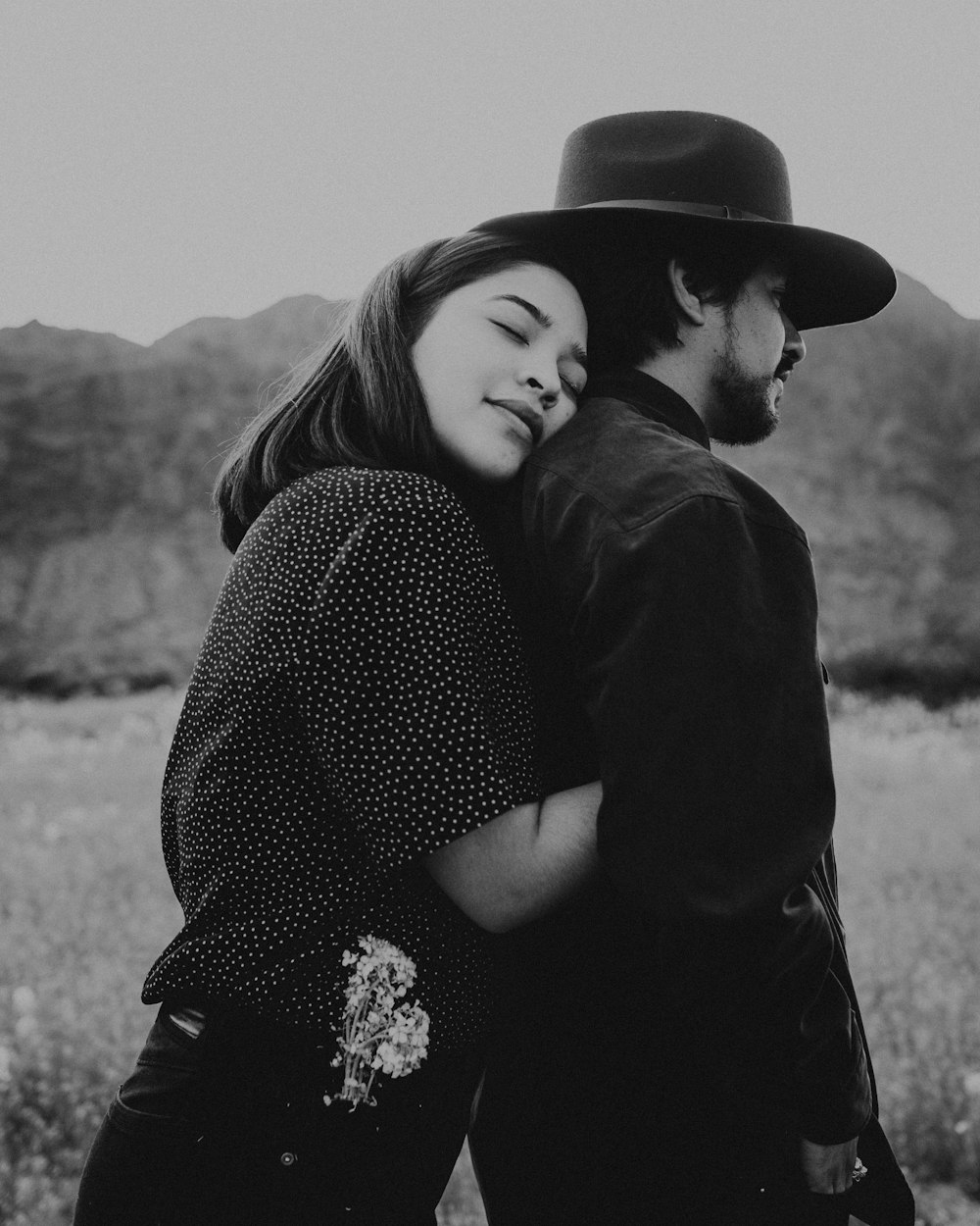 grayscale photo of woman in black long sleeve shirt and black hat