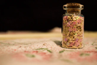 A jar filled with crunchy slime featuring colorful foam beads and tiny charms.